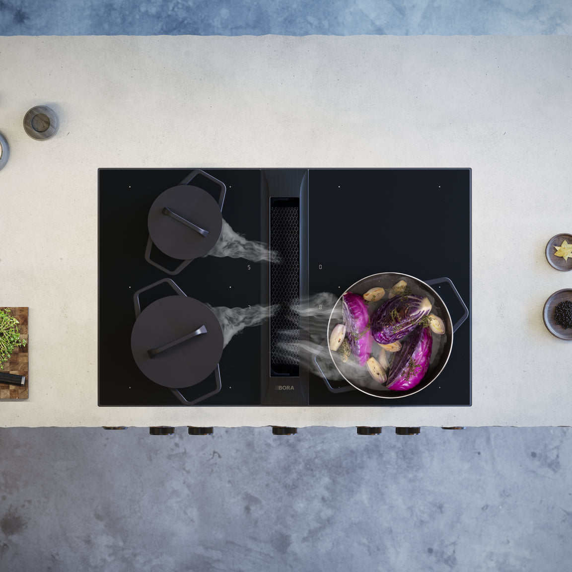 Set BORA Professional 3.0 All Black Rough vu de dessus, casseroles fumantes et ingrédients frais