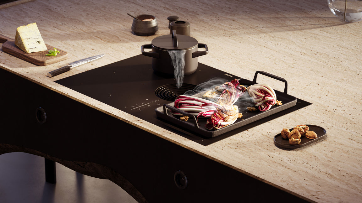 Table aspirante BORA M Pure Rough en verre mat, casserole et radicchio sur un plan de travail en pierre