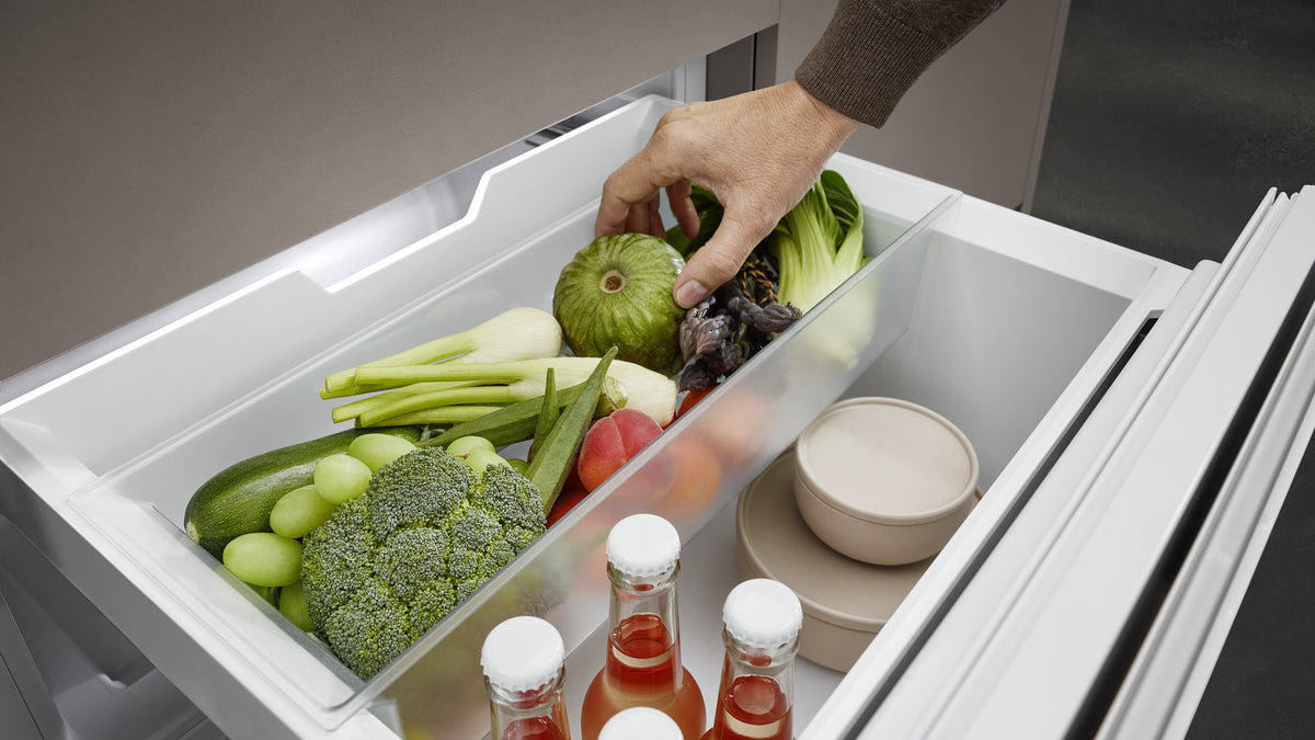 Fruits, légumes et bouteilles, à hauteur de main.